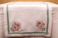 White linen embroidered runner with mint green floral detailing.