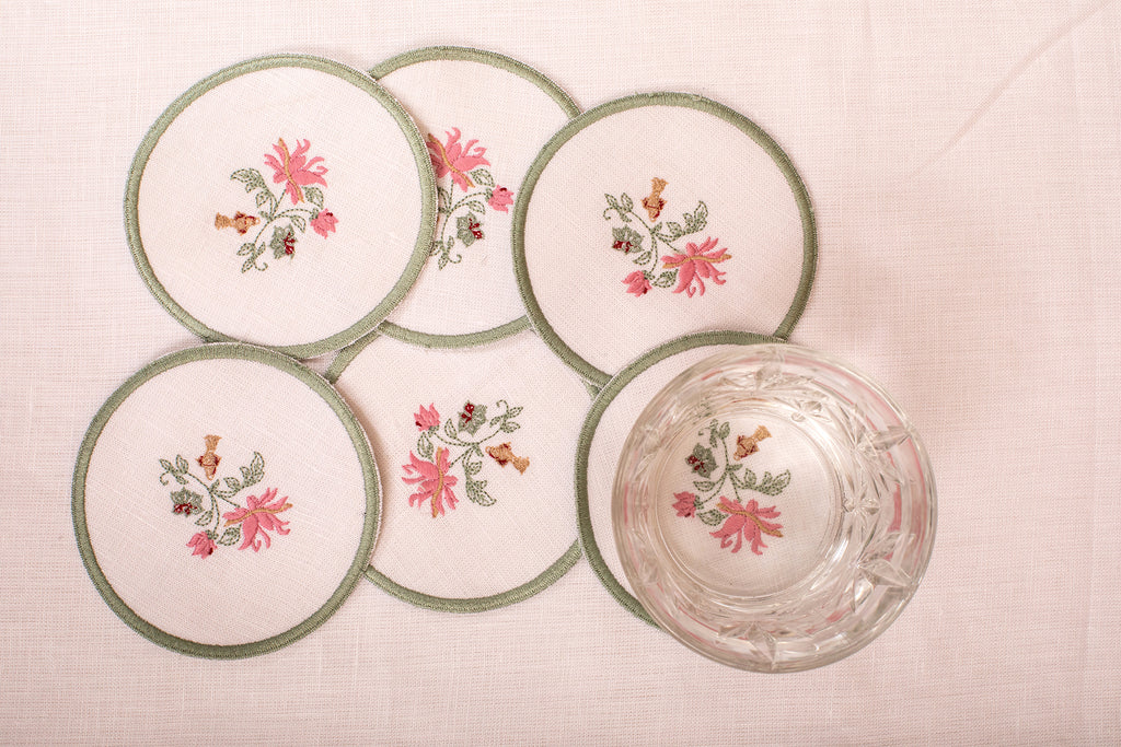 White linen embroidered  coaster with mint green floral detailing.