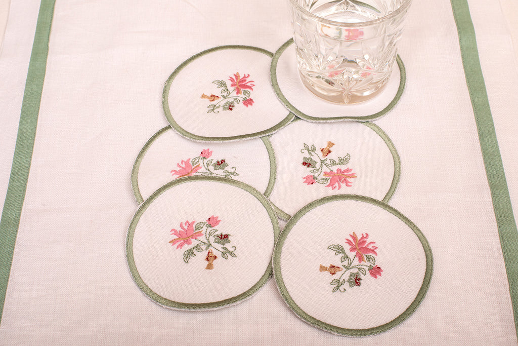 White linen embroidered  coaster with mint green floral detailing.
