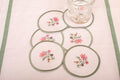 White linen embroidered  coaster with mint green floral detailing.