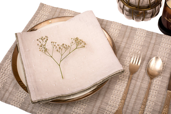 Grey linen placemat with white linen napkin.