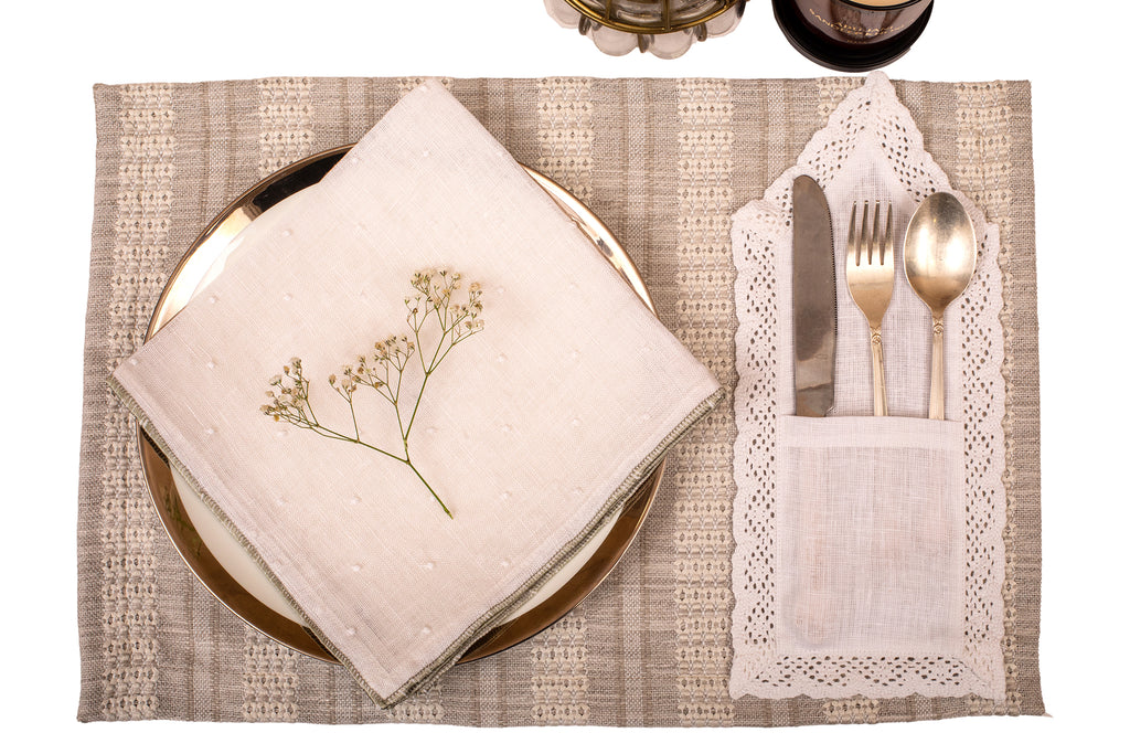 Grey linen placemat with white linen napkin.