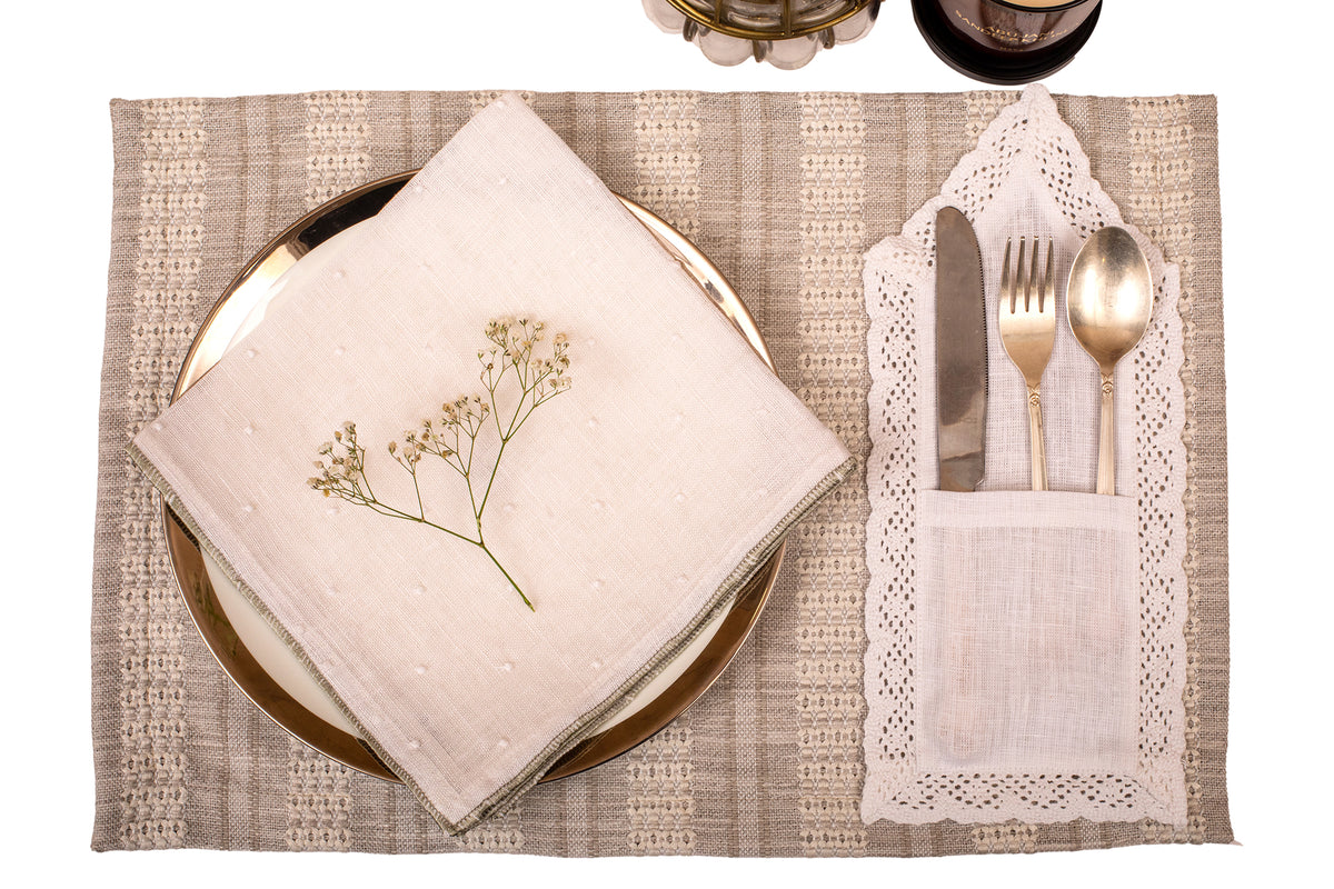 Grey linen placemat with white linen napkin.