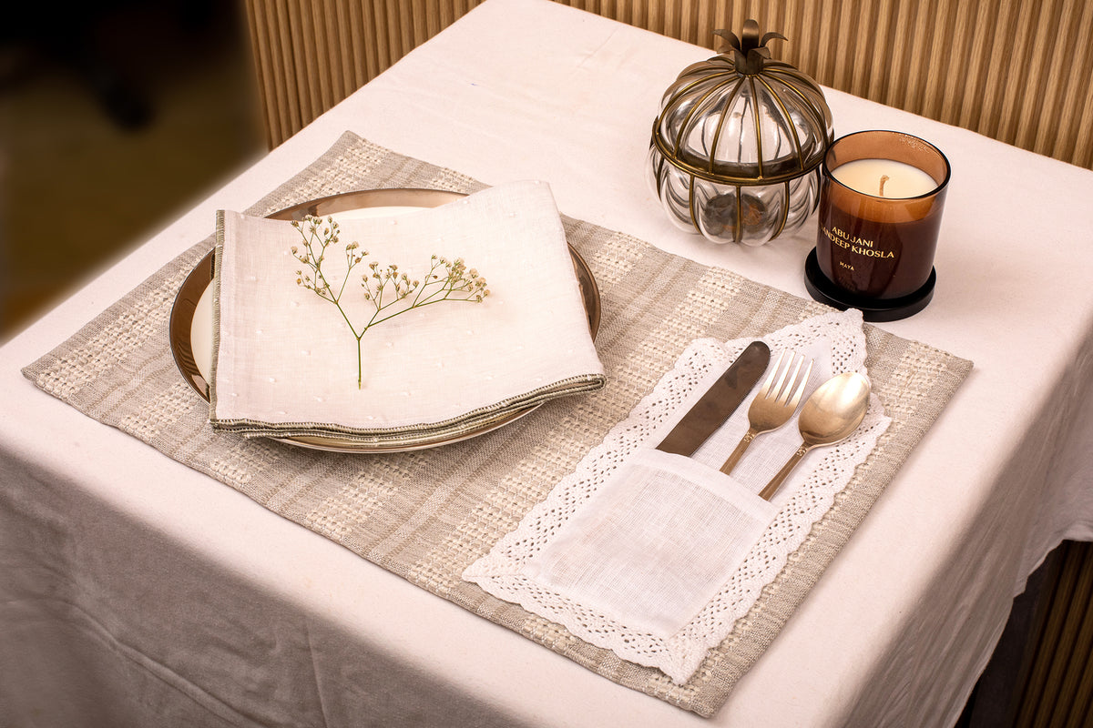 Grey linen placemat with white linen napkin.
