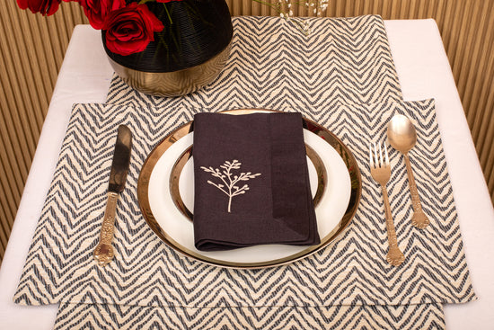 Herringbone  placemat and navy blue linen embroidered napkin.