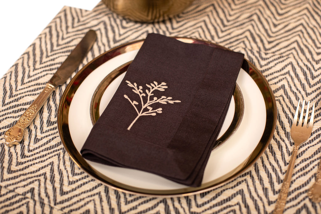 Herringbone  placemat and navy blue linen embroidered napkin.