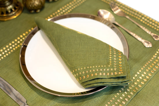 Olive green linen placemat and napkin with delicate embroidery.