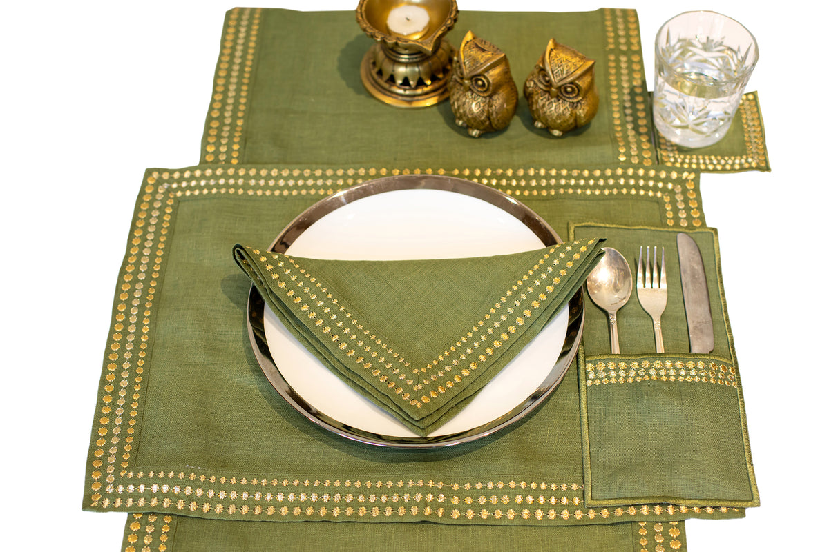 Olive green linen cutlery holder with delicate embroidery.