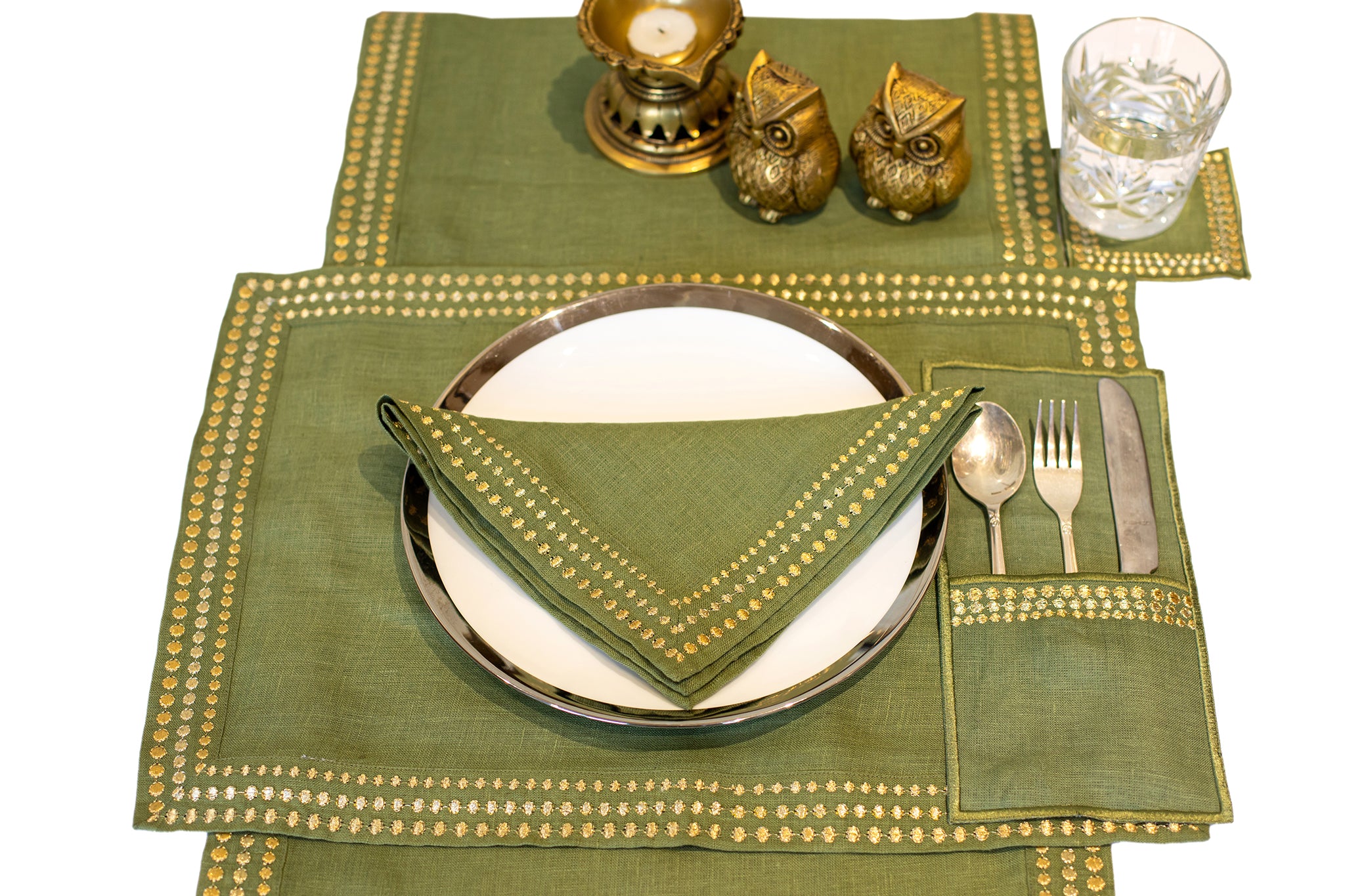 Olive green linen placemat and napkin with delicate embroidery.