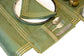 Olive green linen cutlery holder with delicate embroidery.