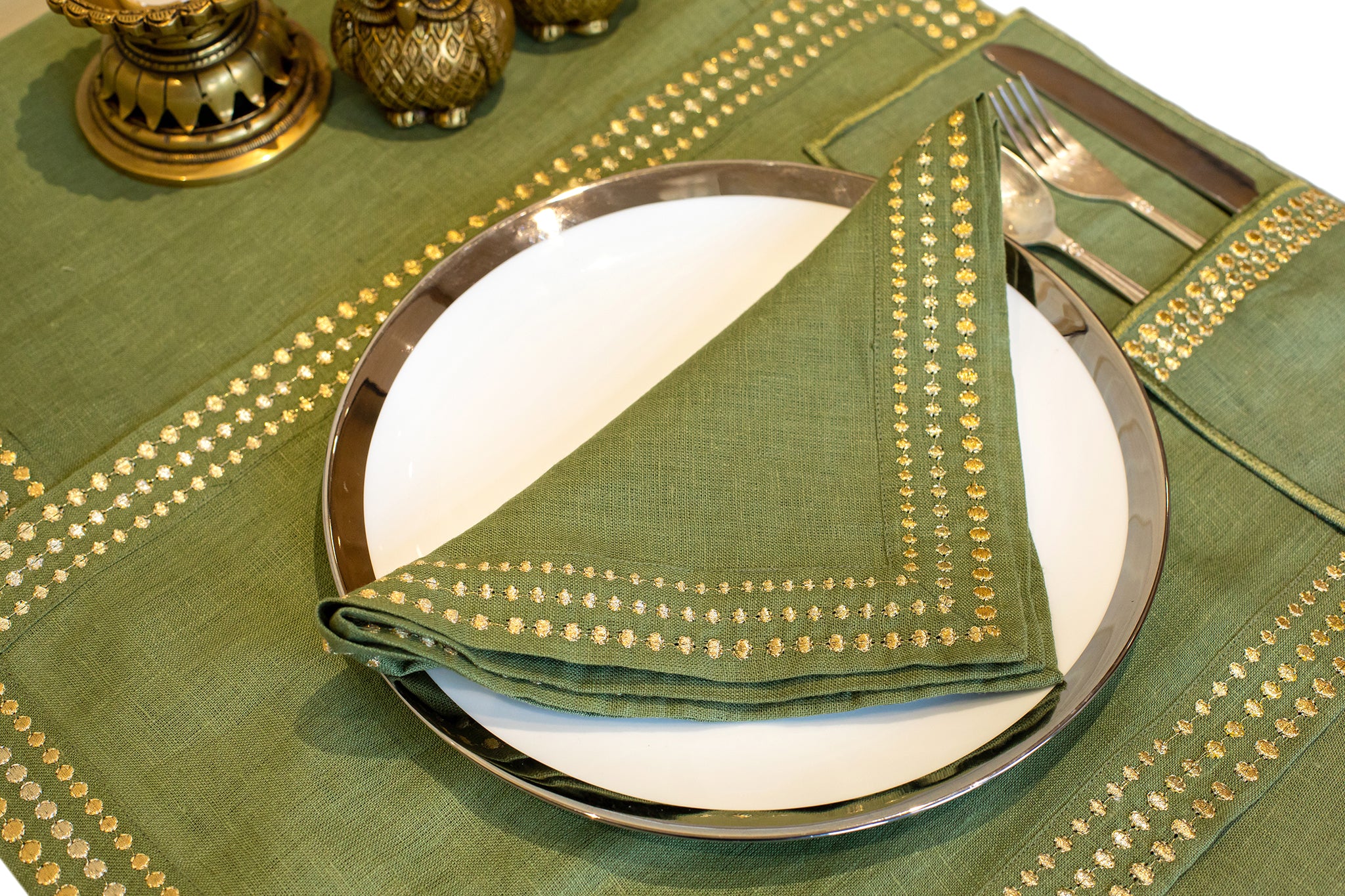 Olive green linen placemat and napkin with delicate embroidery.