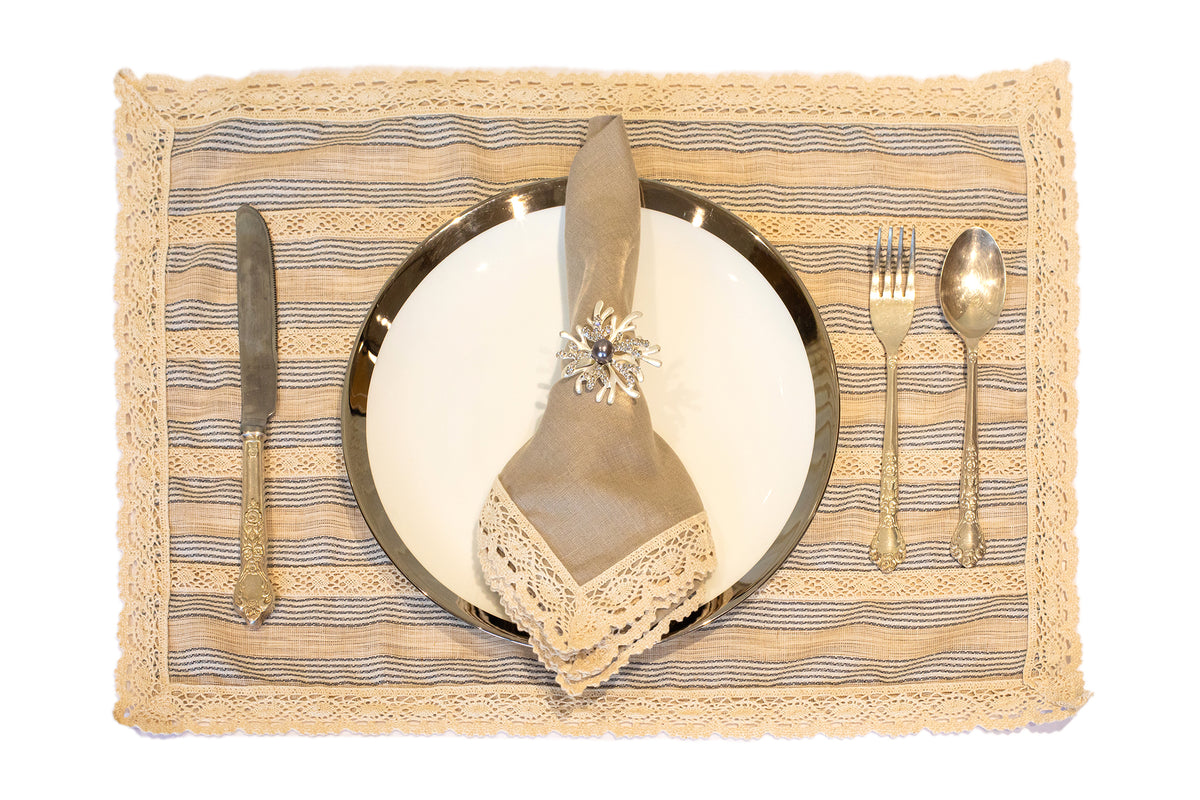 Blue and beige striped linen placemat and napkin with lace detailing.