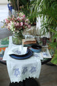 Powder blue linen coaster with embroidered turtle.