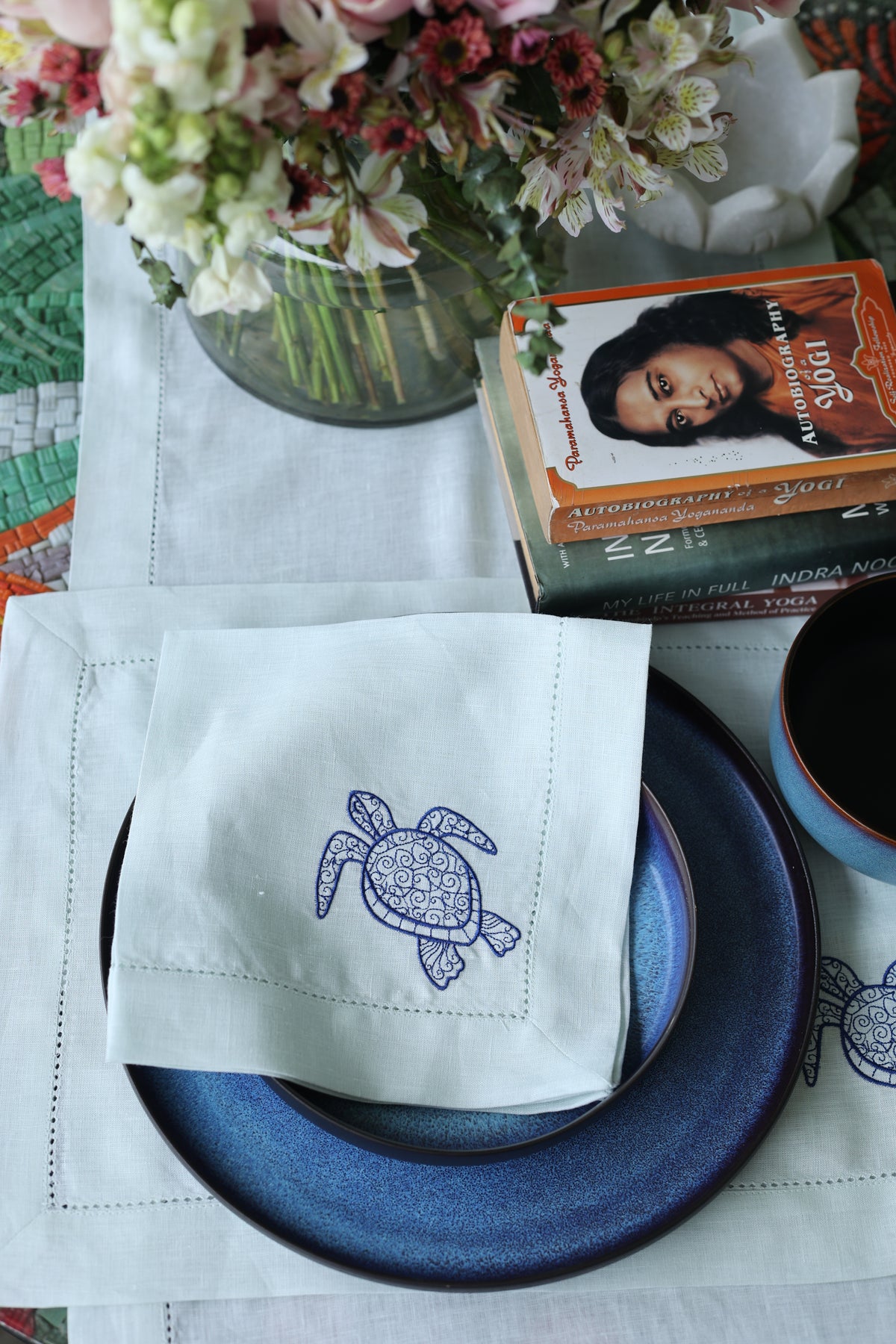 Powder blue linen placemats and napkins with embroidered turtle.