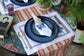 White linen placemats and napkins with embroidered butterfly.