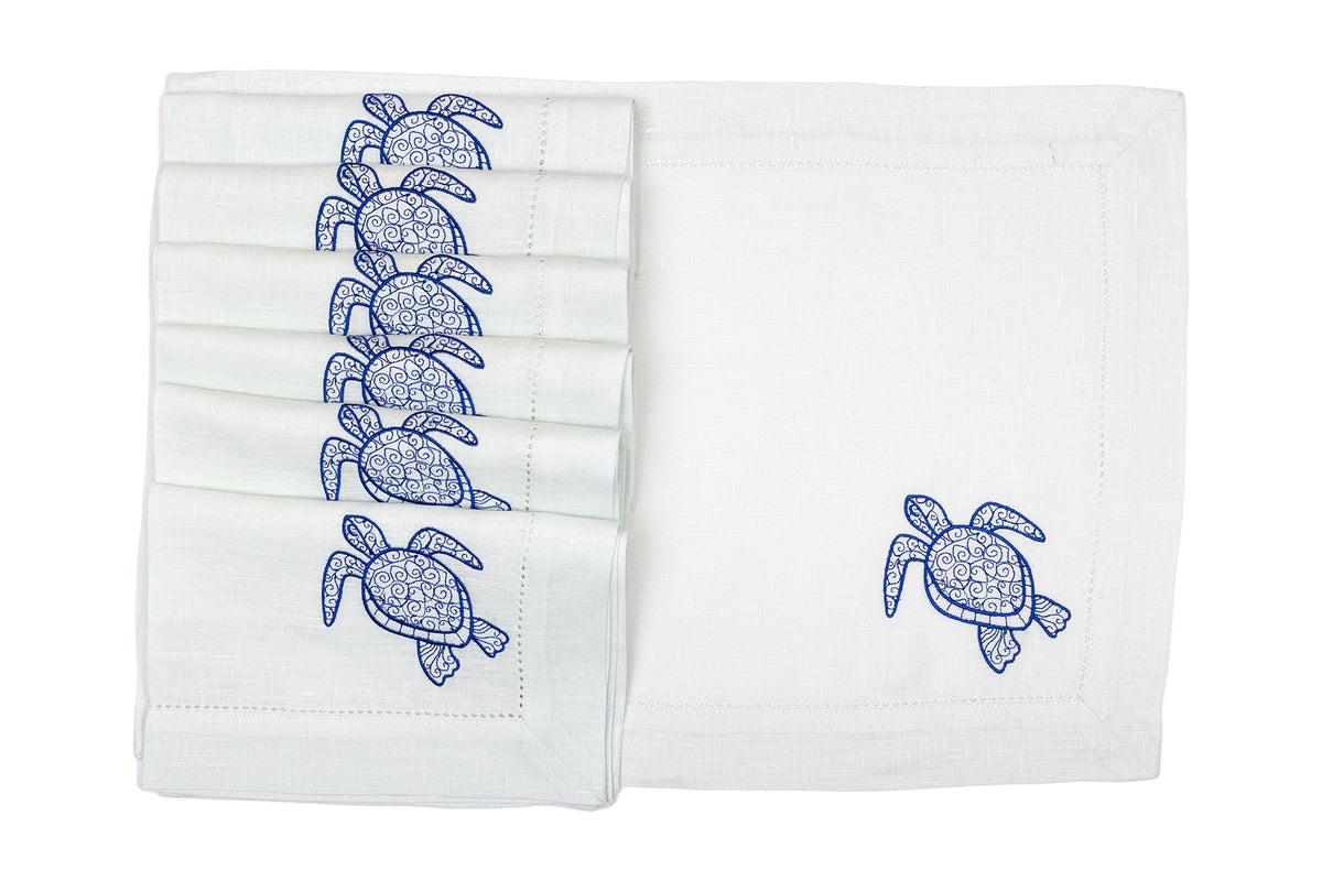 Powder blue linen placemats and napkins with embroidered turtle.