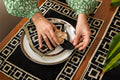 Black linen embroidered placemat and napkin.