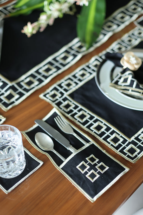 Black linen embroidered cutlery holder.