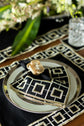Black linen embroidered placemat and napkin.