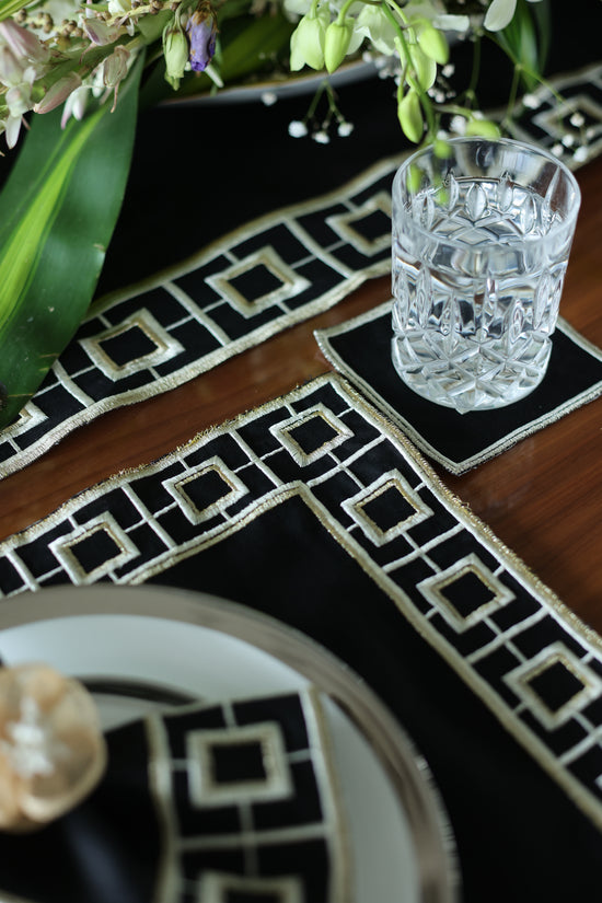 Black linen embroidered coaster.