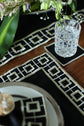 Black linen embroidered coaster.