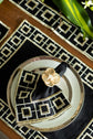 Black linen embroidered placemat and napkin.