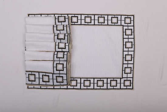 White linen embroidered placemat and napkin.