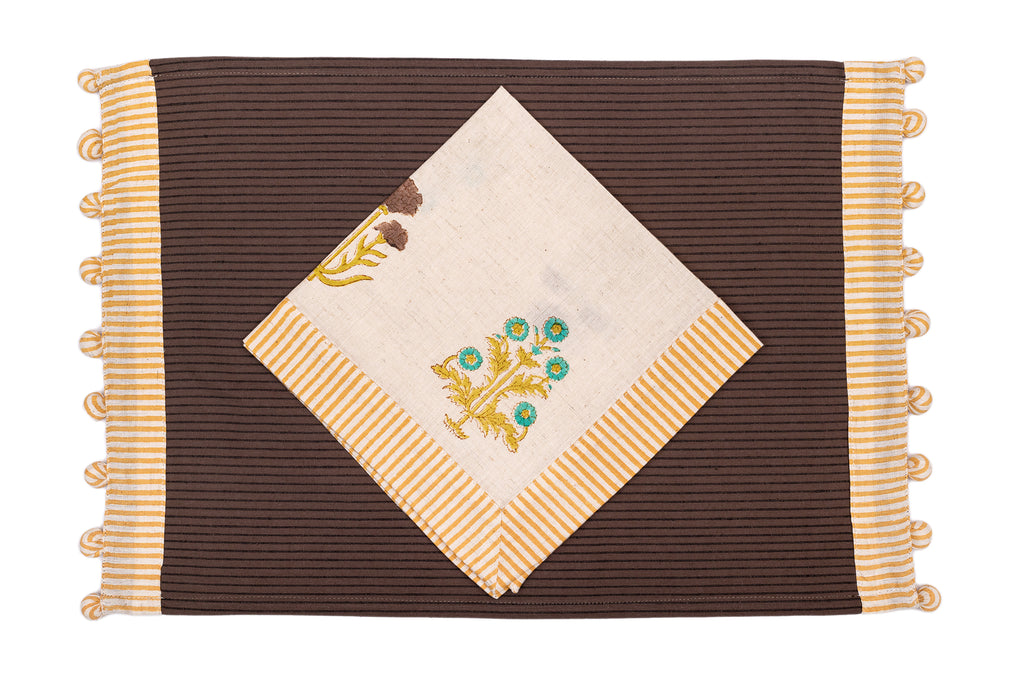 Brown linen placemat with striped flange and printed linen napkin.