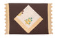 Brown linen placemat with striped flange and printed linen napkin.