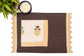 Brown linen placemat with striped flange and printed linen napkin.
