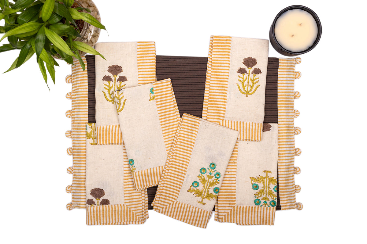 Brown linen placemat with striped flange and printed linen napkin.
