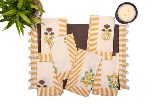 Brown linen placemat with striped flange and printed linen napkin.