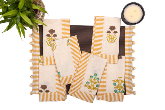 Brown linen placemat with striped flange and printed linen napkin.