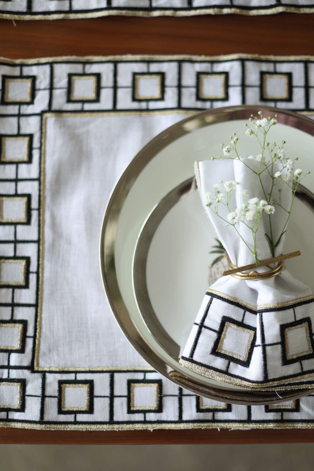 White linen embroidered placemat and napkin.