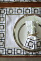 White linen embroidered placemat and napkin.