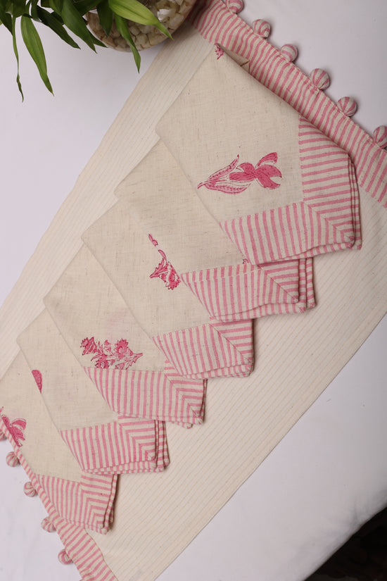Cream linen placemat with striped flange and printed linen napkin.