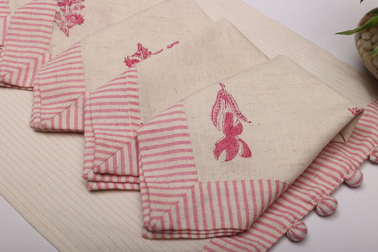 Cream linen placemat with striped flange and printed linen napkin.