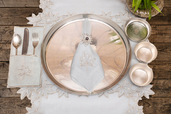 Powder blue linen placemat and napkin with silver cutwork embroidered.