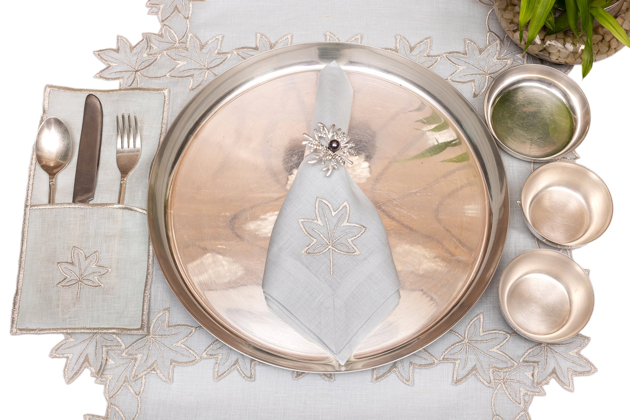 Powder blue linen placemat and napkin with silver cutwork embroidered.