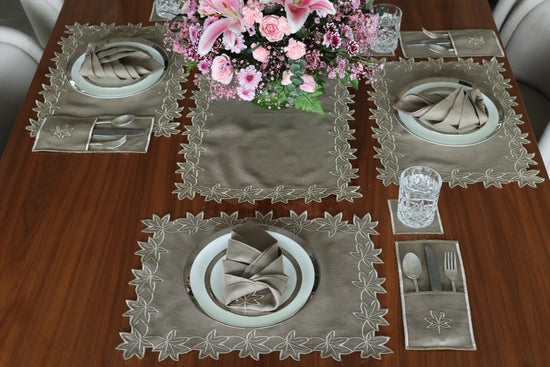Brown linen runner with gold cutwork embroidery.