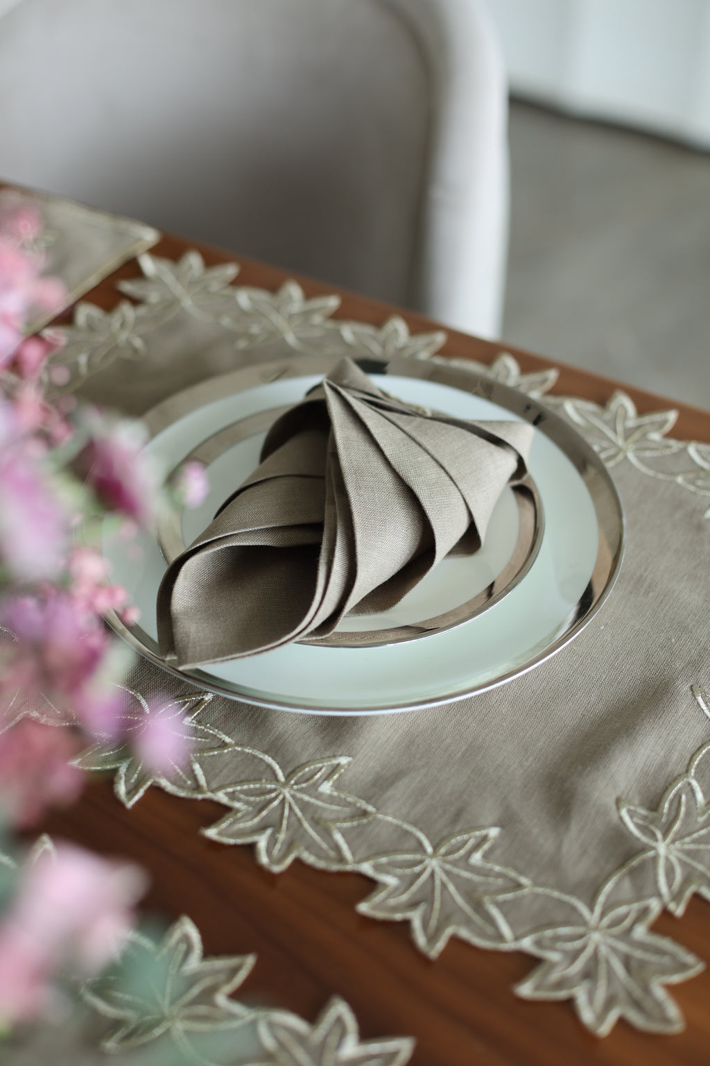 Brown linen placemats and napkins with gold  cutwork embroidery.