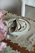 Brown linen placemats and napkins with gold  cutwork embroidery.