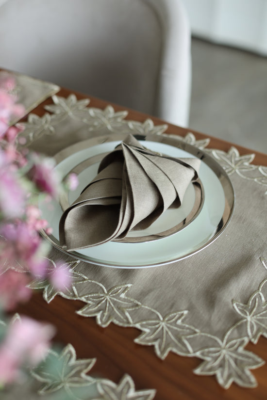 Brown linen placemats and napkins with gold  cutwork embroidery.