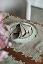 Brown linen placemats and napkins with gold  cutwork embroidery.