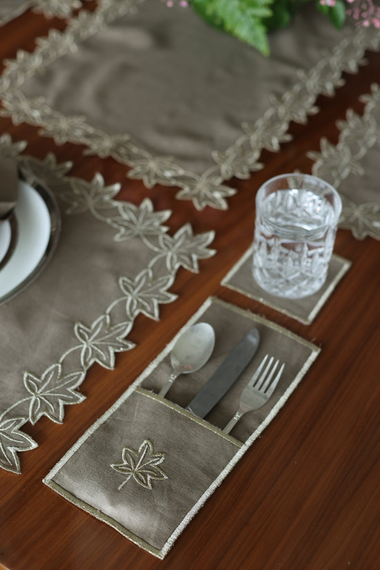 Brown linen gold maple leaf coaster.