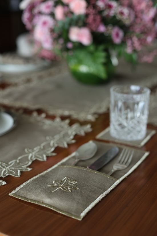 Brown linen gold maple leaf coaster.