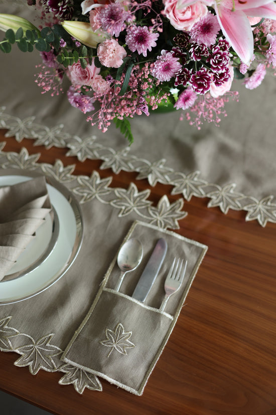 Brown linen placemats and napkins with gold  cutwork embroidery.