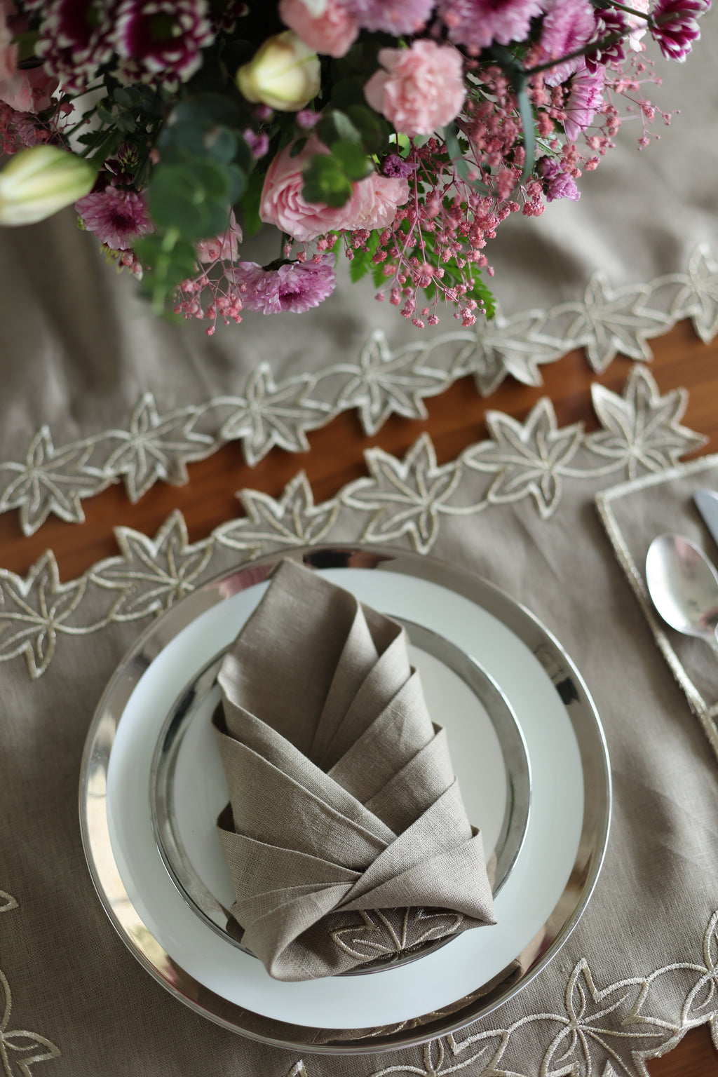Brown linen placemats and napkins with gold  cutwork embroidery.