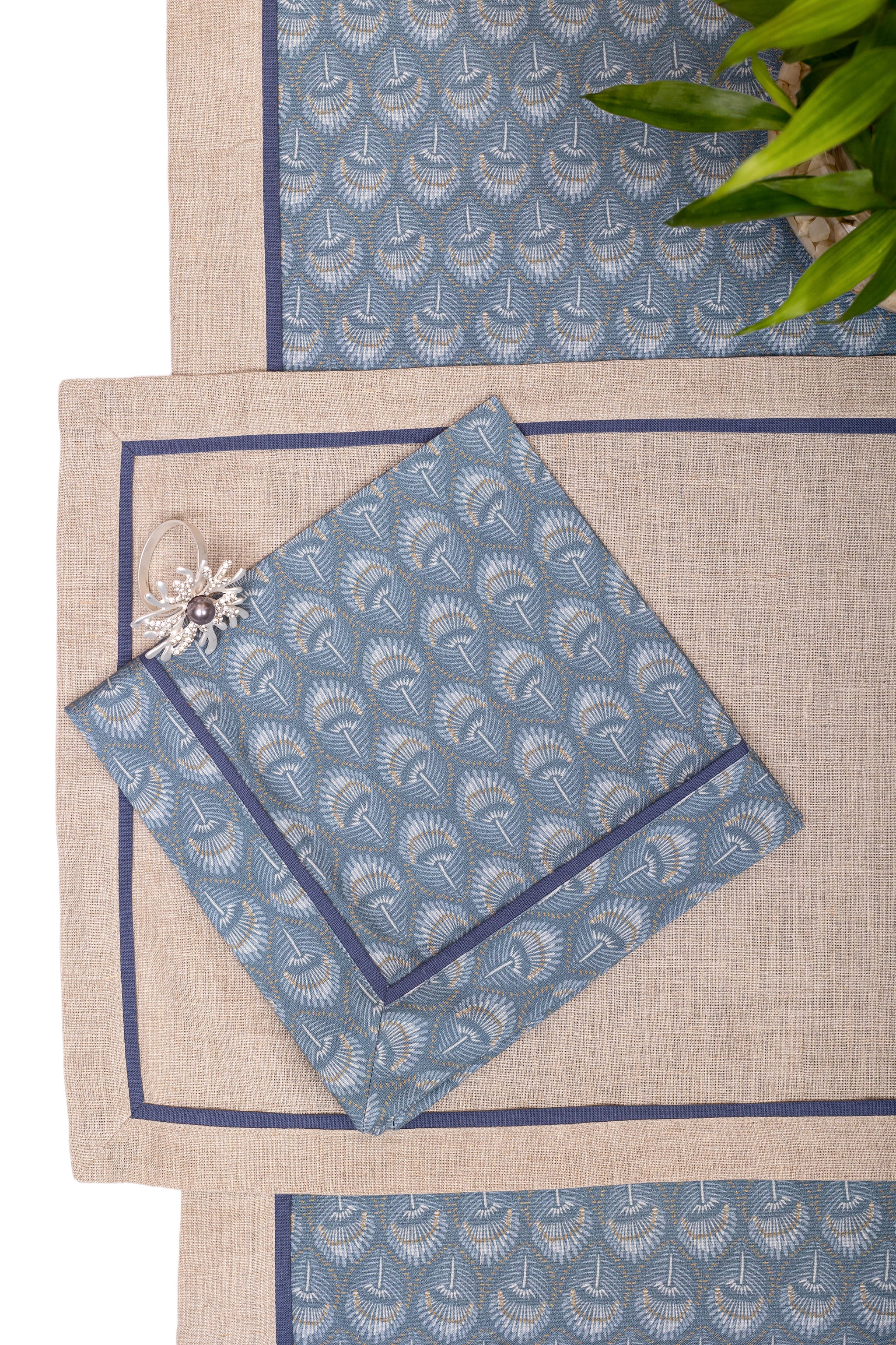 Natural linen placemats with blue peacock print linen napkin.