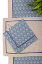 Natural linen placemats with blue peacock print linen napkin.